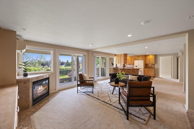 639 N Riverpoint Blvd Unit J201/J202, Spokane, WA 99202 - living room with a fireplace with flush hearth, light carpet, and recessed lighting
