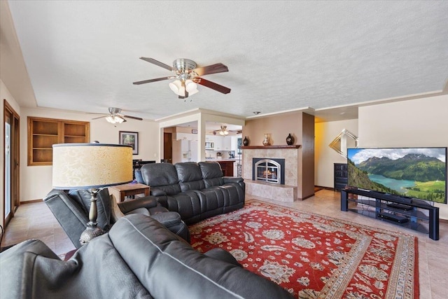 2515 E 38th Ave, Spokane, WA 99223 - living room with a ceiling fan, a fireplace, light tile patterned floors, and a textured ceiling