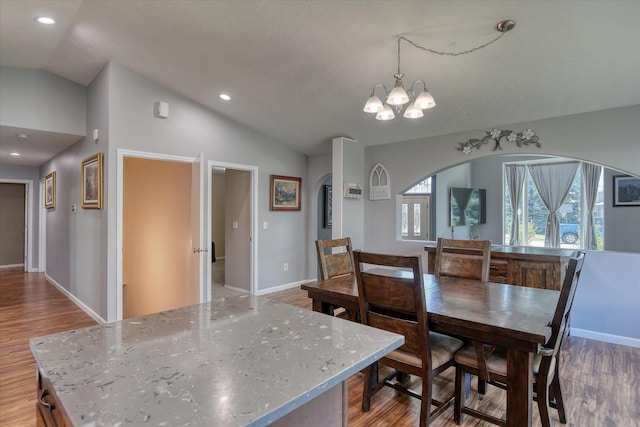 4318 N Upland Ct, Spokane Valley, WA 99216 - dining room featuring arched walkways, light wood-type flooring, lofted ceiling, a chandelier, and recessed lighting