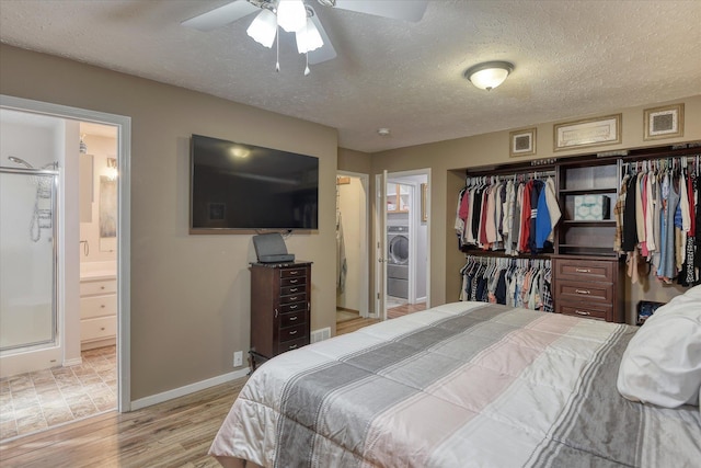 4318 N Upland Ct, Spokane Valley, WA 99216 - bedroom with a closet, light wood finished floors, washer / clothes dryer, a textured ceiling, and ensuite bath