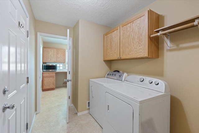 34 E Euclid Ave, Spokane, WA 99207 - laundry area featuring washing machine and clothes dryer, cabinet space, a textured ceiling, and light colored carpet