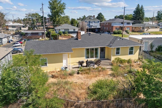 34 E Euclid Ave, Spokane, WA 99207 - back of property featuring a residential view, a shingled roof, and a chimney
