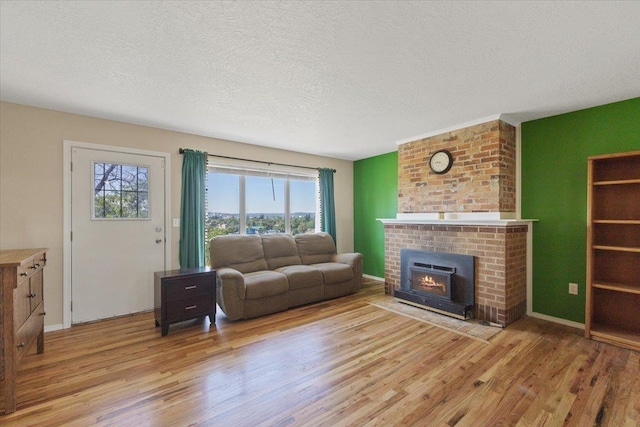 34 E Euclid Ave, Spokane, WA 99207 - living area with wood finished floors, a textured ceiling, and a fireplace