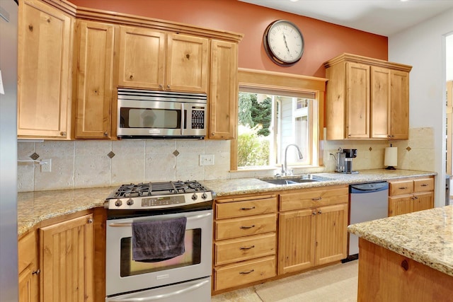 11425 N Lloyd Charles Ln, Spokane, WA 99218 - kitchen featuring appliances with stainless steel finishes, tasteful backsplash, light brown cabinets, and light stone countertops