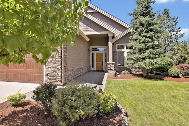11425 N Lloyd Charles Ln, Spokane, WA 99218 - property entrance with stone siding, a lawn, and concrete driveway