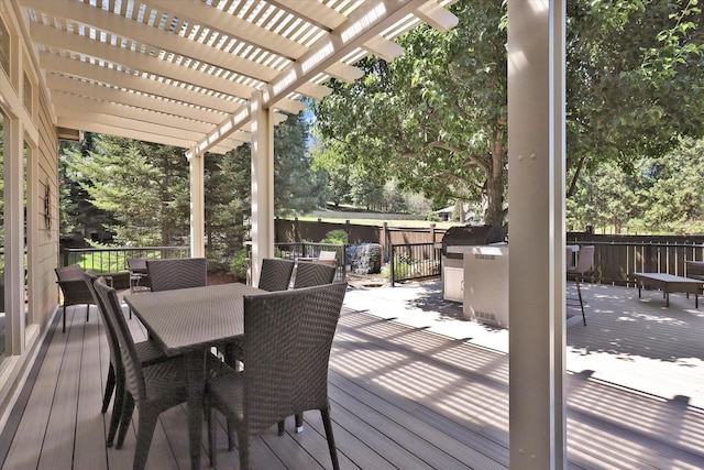 11425 N Lloyd Charles Ln, Spokane, WA 99218 - deck featuring outdoor dining area, a pergola, and view of wooded area