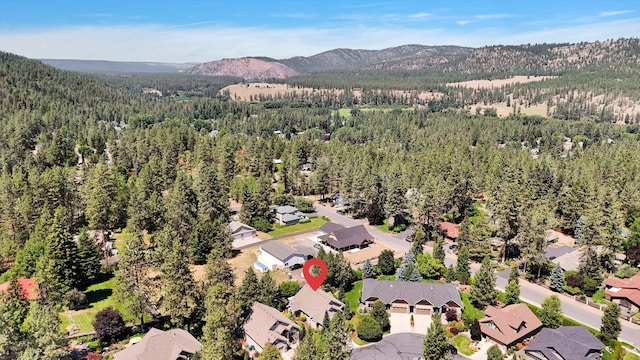 11425 N Lloyd Charles Ln, Spokane, WA 99218 - aerial perspective of suburban area with a heavily wooded area and a mountainous background