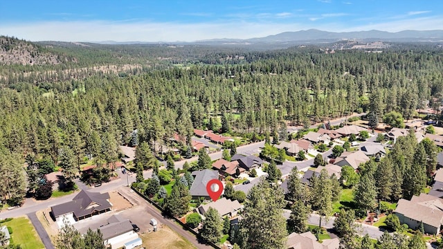 11425 N Lloyd Charles Ln, Spokane, WA 99218 - aerial perspective of suburban area featuring a forest and a mountain backdrop