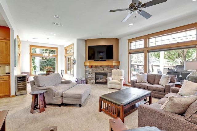11425 N Lloyd Charles Ln, Spokane, WA 99218 - living room featuring wine cooler, healthy amount of natural light, a chandelier, a fireplace, and recessed lighting