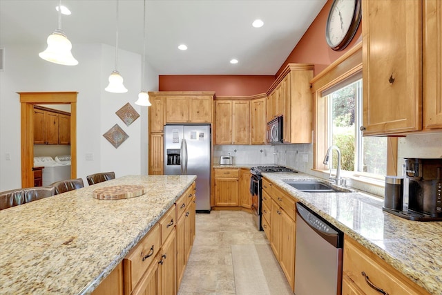 11425 N Lloyd Charles Ln, Spokane, WA 99218 - kitchen with appliances with stainless steel finishes, washer and dryer, light stone counters, tasteful backsplash, and recessed lighting