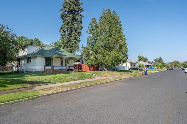 1019 E Everett Ave, Spokane, WA 99207 - view of front facade with covered porch, a front yard, and a residential view