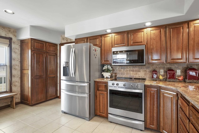 3333 N Ashton Rd, Otis Orchards, WA 99027 - kitchen with stainless steel appliances, light stone counters, tasteful backsplash, light tile patterned flooring, and recessed lighting