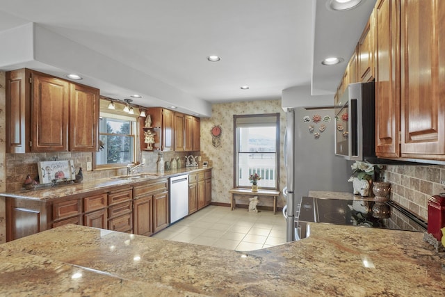 3333 N Ashton Rd, Otis Orchards, WA 99027 - kitchen with stainless steel appliances, light tile patterned floors, light stone countertops, brown cabinets, and recessed lighting