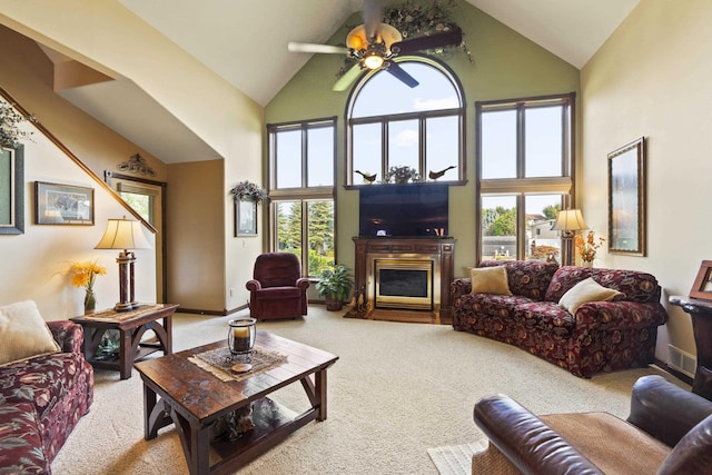 3333 N Ashton Rd, Otis Orchards, WA 99027 - carpeted living area with high vaulted ceiling, plenty of natural light, a fireplace with flush hearth, and a ceiling fan