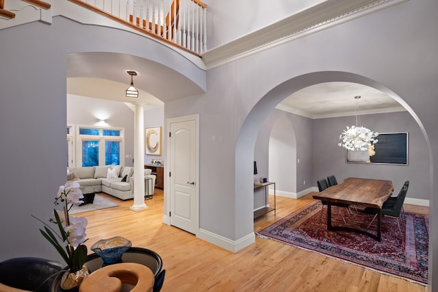 1807 E Pinegate Ln, Spokane, WA 99224 - entrance foyer featuring wood finished floors, ornamental molding, arched walkways, and a chandelier