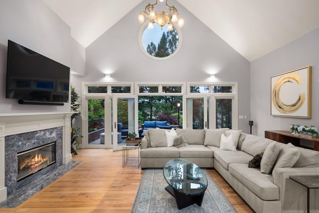 1807 E Pinegate Ln, Spokane, WA 99224 - living area featuring high vaulted ceiling, wood finished floors, french doors, a fireplace, and healthy amount of natural light