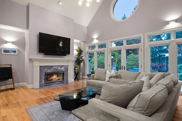 1807 E Pinegate Ln, Spokane, WA 99224 - living room featuring high vaulted ceiling, wood finished floors, and a premium fireplace