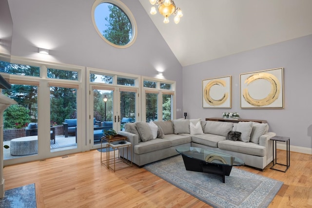 1807 E Pinegate Ln, Spokane, WA 99224 - living room featuring high vaulted ceiling, french doors, plenty of natural light, light wood-style floors, and a chandelier