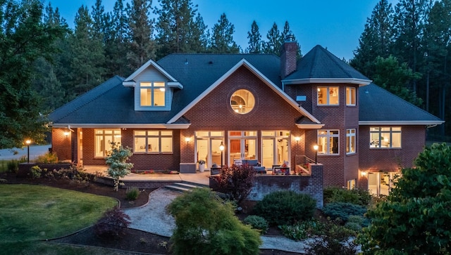 1807 E Pinegate Ln, Spokane, WA 99224 - rear view of property featuring a chimney, brick siding, a patio, and a lawn