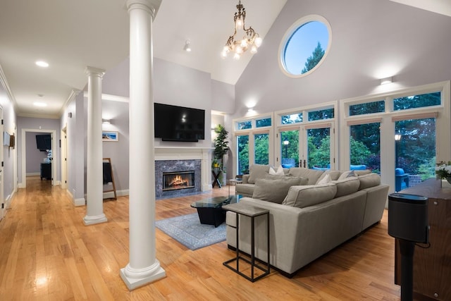 1807 E Pinegate Ln, Spokane, WA 99224 - living room featuring decorative columns, a high end fireplace, high vaulted ceiling, light wood-style floors, and ornamental molding