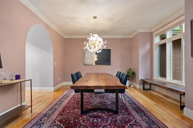 1807 E Pinegate Ln, Spokane, WA 99224 - dining space with wood finished floors, arched walkways, crown molding, and a chandelier