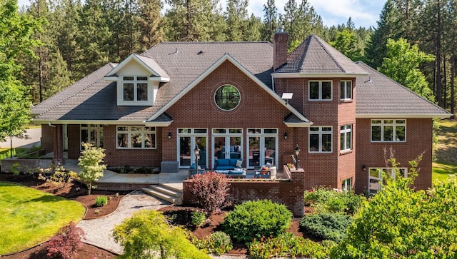 1807 E Pinegate Ln, Spokane, WA 99224 - rear view of house featuring a chimney, a patio, brick siding, and outdoor lounge area