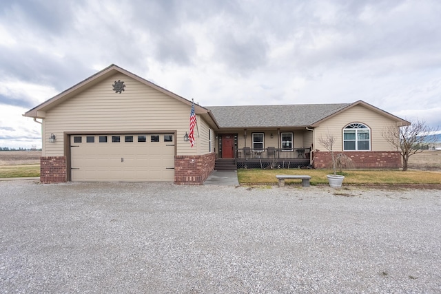 8715 W Antler Rd, Deer Park, WA 99006 - single story home with brick siding, driveway, a garage, covered porch, and a shingled roof