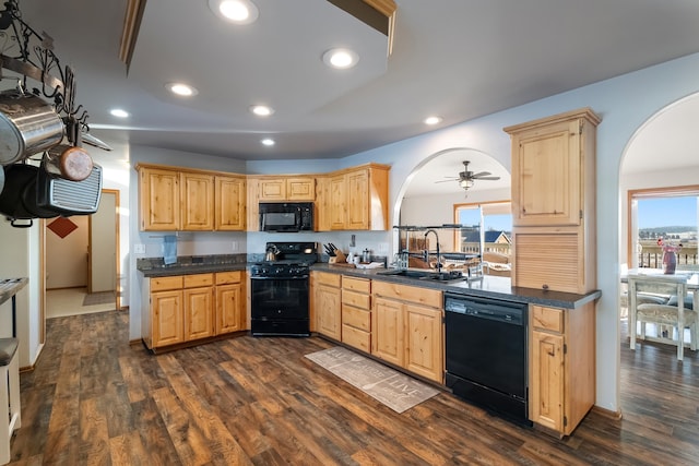 8715 W Antler Rd, Deer Park, WA 99006 - kitchen with black appliances, arched walkways, light brown cabinetry, dark countertops, and recessed lighting