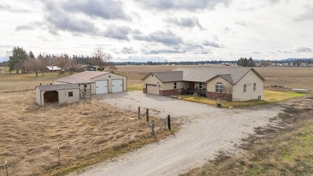 8715 W Antler Rd, Deer Park, WA 99006 - ranch-style home with a garage, an outbuilding, a view of countryside, driveway, and brick siding