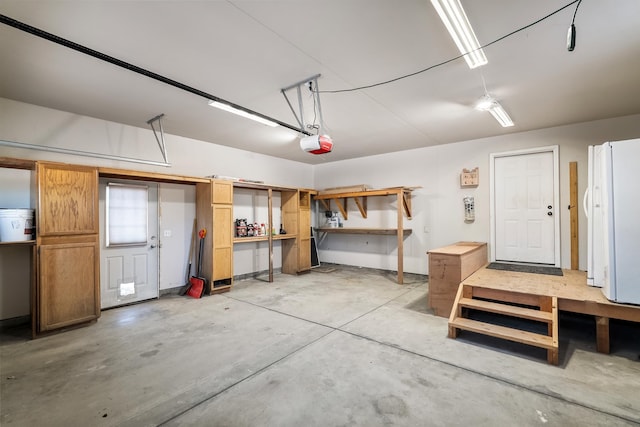8715 W Antler Rd, Deer Park, WA 99006 - garage with a garage door opener, a workshop area, and freestanding refrigerator
