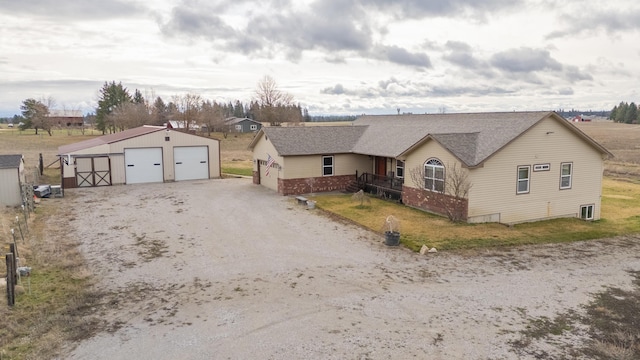 8715 W Antler Rd, Deer Park, WA 99006 - ranch-style home featuring a garage, an outdoor structure, and roof with shingles