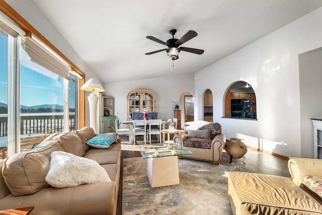 8715 W Antler Rd, Deer Park, WA 99006 - living area with lofted ceiling, ceiling fan, wood finished floors, a mountain view, and arched walkways