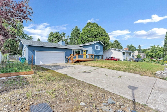 15217 E 15th Ave, Spokane Valley, WA 99037 - split level home featuring concrete driveway, a deck, and a garage
