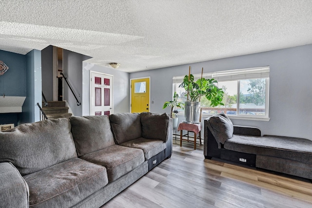 15217 E 15th Ave, Spokane Valley, WA 99037 - living room with stairs, wood finished floors, and a textured ceiling