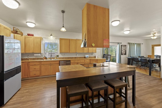 20902 S Ritchey Rd, Spokane, WA 99004 - kitchen with freestanding refrigerator, healthy amount of natural light, light wood finished floors, and stainless steel dishwasher