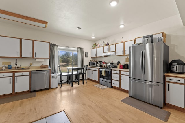 20902 S Ritchey Rd, Spokane, WA 99004 - kitchen featuring stainless steel appliances, under cabinet range hood, light countertops, white cabinetry, and recessed lighting