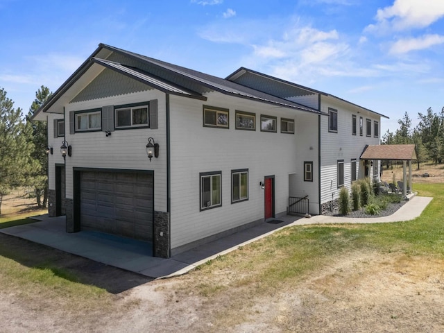 20902 S Ritchey Rd, Spokane, WA 99004 - view of front of property with a garage, stone siding, driveway, and a front lawn