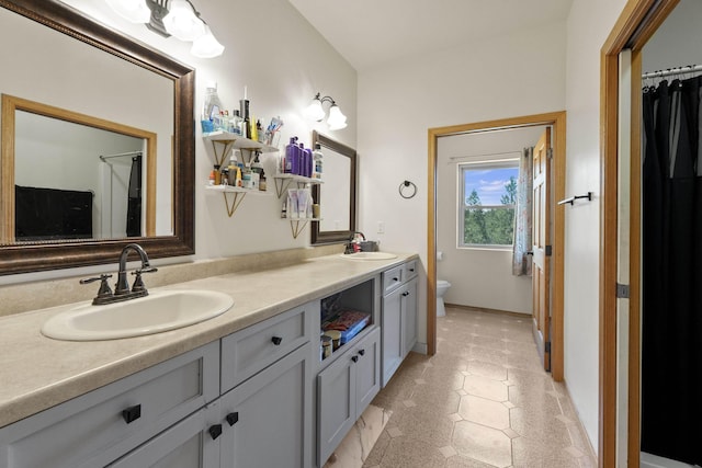 20902 S Ritchey Rd, Spokane, WA 99004 - bathroom featuring double vanity and toilet