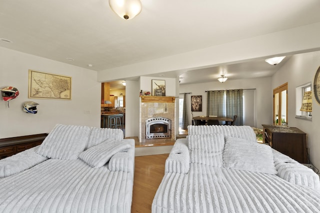 20902 S Ritchey Rd, Spokane, WA 99004 - bedroom with heating unit, light wood-style floors, and a tiled fireplace