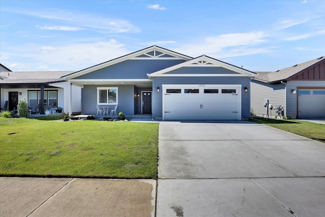 10521 W Salmonberry Rd, Cheney, WA 99004 - ranch-style home with a garage, a front lawn, concrete driveway, and covered porch