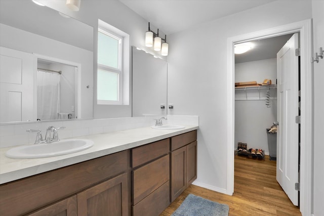 10521 W Salmonberry Rd, Cheney, WA 99004 - full bathroom featuring double vanity, wood finished floors, and a spacious closet