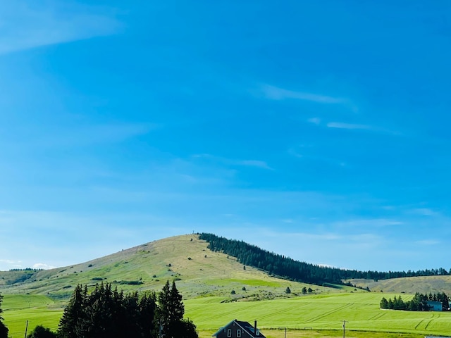 view of mountain background featuring rural landscape