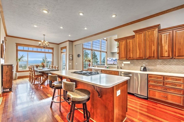 6808 S Jackson Ridge Ln, Greenacres, WA 99016 - kitchen featuring a center island, a chandelier, light wood-style flooring, light countertops, and ornamental molding