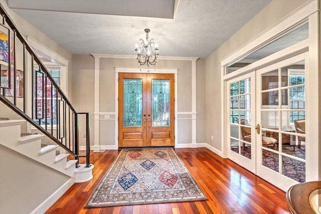 6808 S Jackson Ridge Ln, Greenacres, WA 99016 - entryway with french doors, wood finished floors, a chandelier, a textured ceiling, and stairway