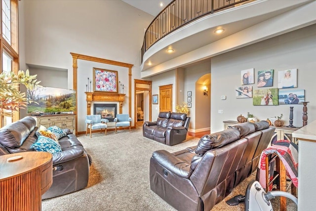 6808 S Jackson Ridge Ln, Greenacres, WA 99016 - living room with a glass covered fireplace, carpet, a high ceiling, and arched walkways