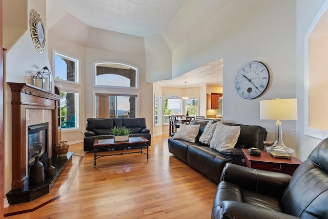8708 E Redwood Ln, Spokane, WA 99217 - living area featuring a high ceiling, light wood-style flooring, and a tile fireplace