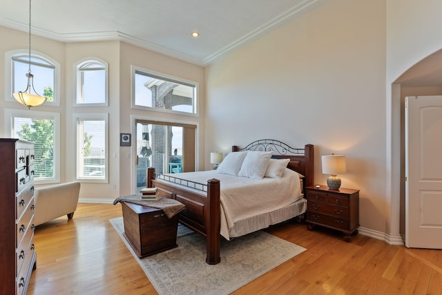 8708 E Redwood Ln, Spokane, WA 99217 - bedroom with arched walkways, light wood-style flooring, a towering ceiling, recessed lighting, and ornamental molding