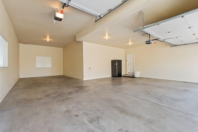 8708 E Redwood Ln, Spokane, WA 99217 - garage with a garage door opener and baseboards