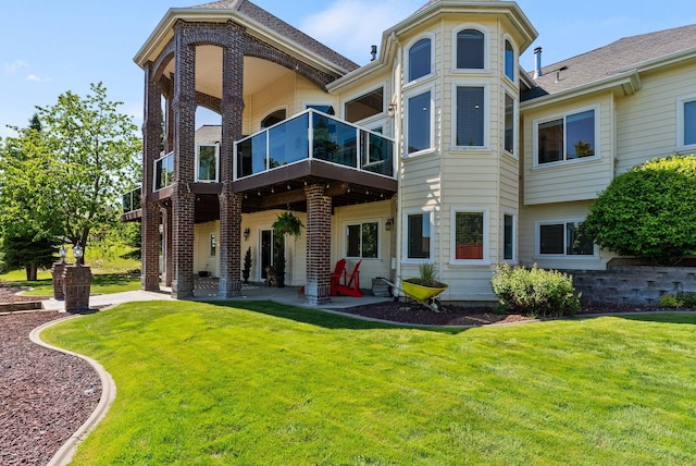 8708 E Redwood Ln, Spokane, WA 99217 - rear view of property with a lawn, a balcony, a patio area, and brick siding