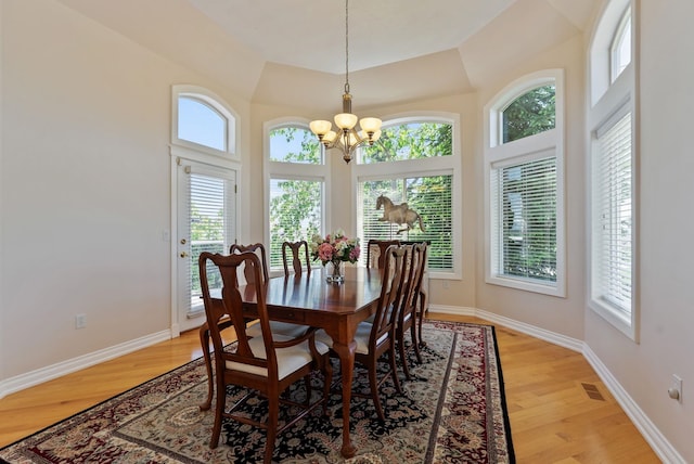 8708 E Redwood Ln, Spokane, WA 99217 - dining space with a chandelier, light wood-style flooring, and a towering ceiling